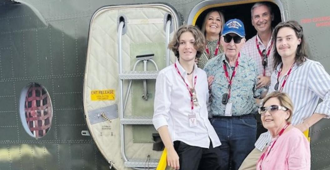 A family of six pose for photo at door of Caribo aircraft