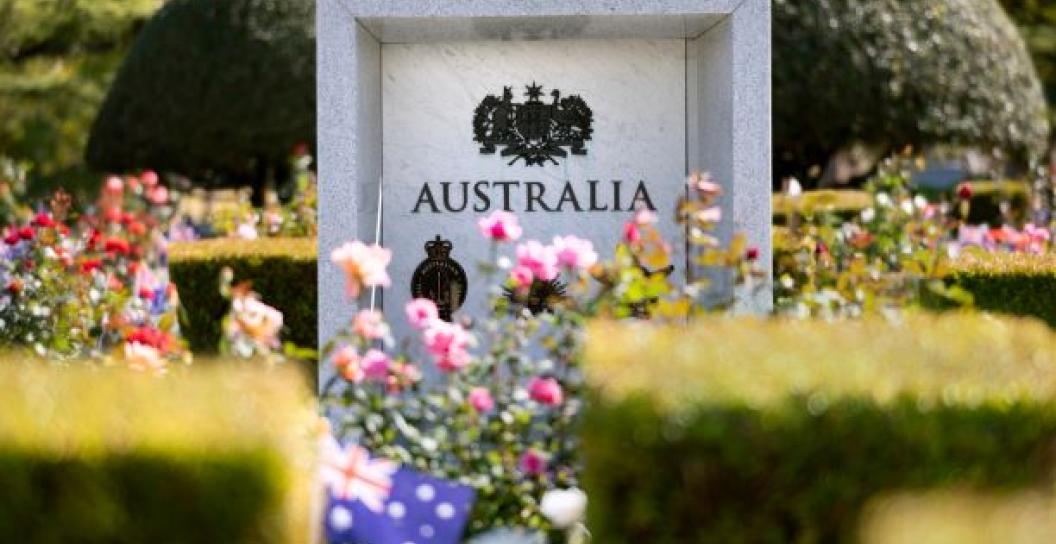 Military memorial stone plinth with flowers