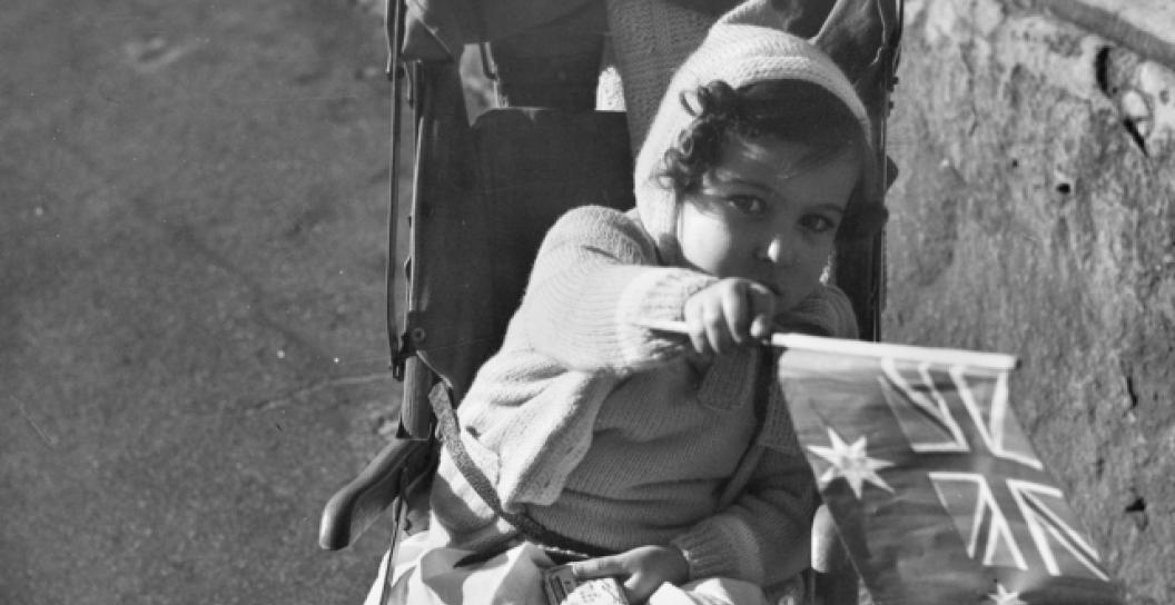 Girl waving a flag on VE Day 1945