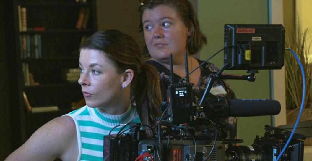 Two women at a movie camera