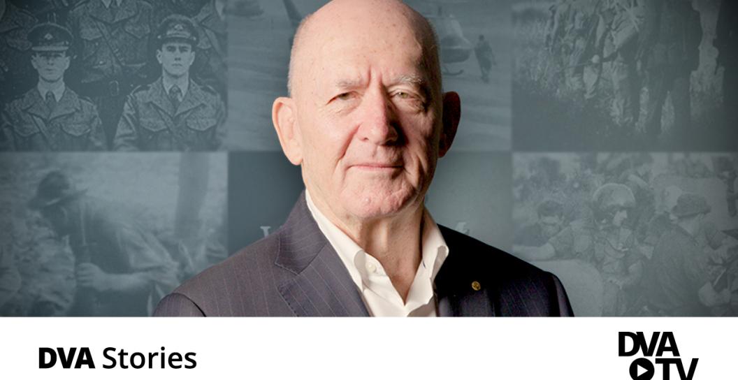 Sir Peter Cosgrove smiling with mouth closed, photos of vietnam images in the background