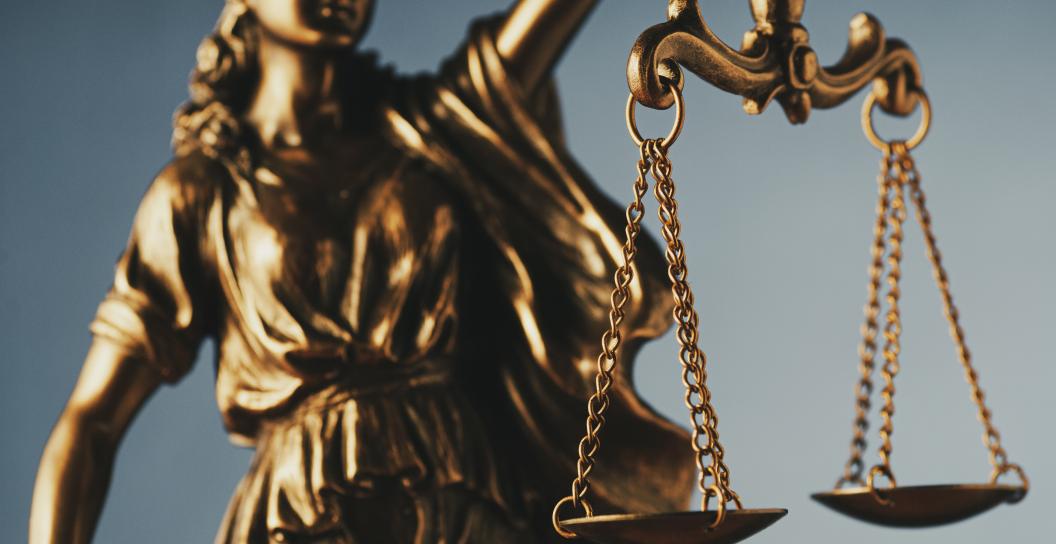 Bronze statue of justice holding scales