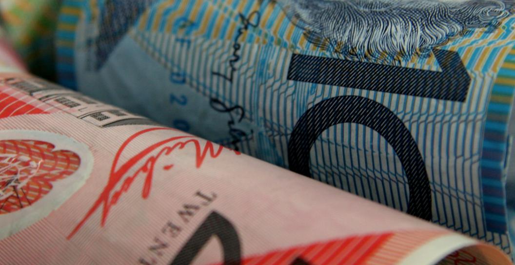 One twenty dollar note, one ten dollar note and one five dollar note in Australian currency.