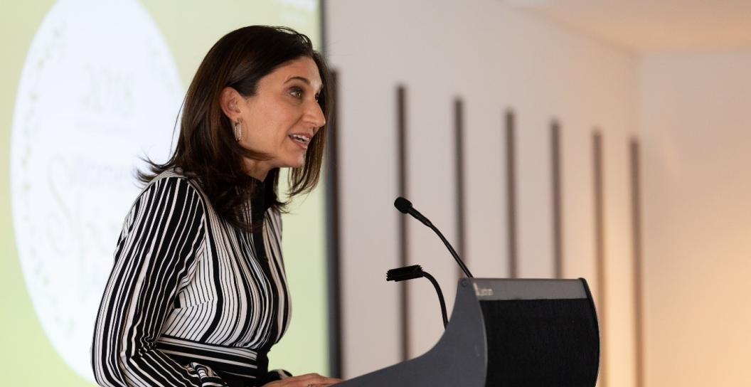 Woman speaking at lectern