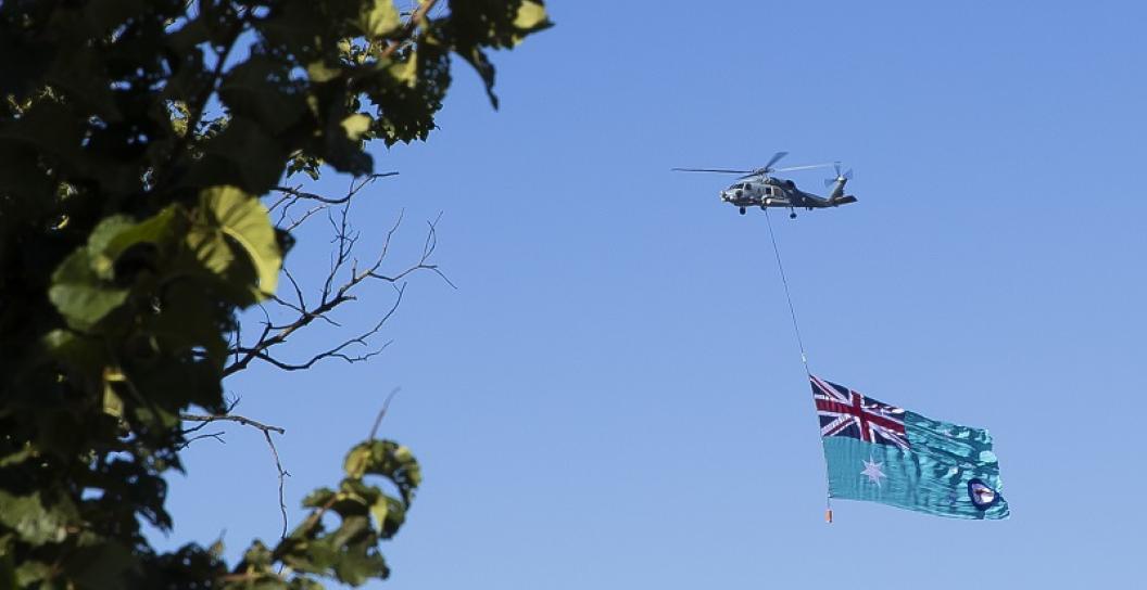 Helicopter towing RAAF flag