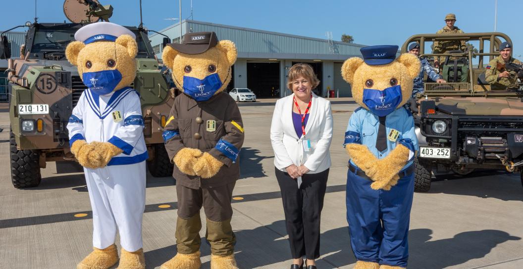 Woman with giant teddy bears on either side