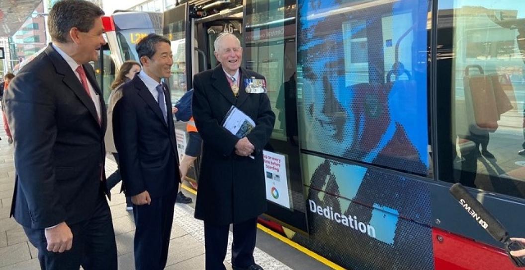 Sydney Light Rail vehicles with Korean War images