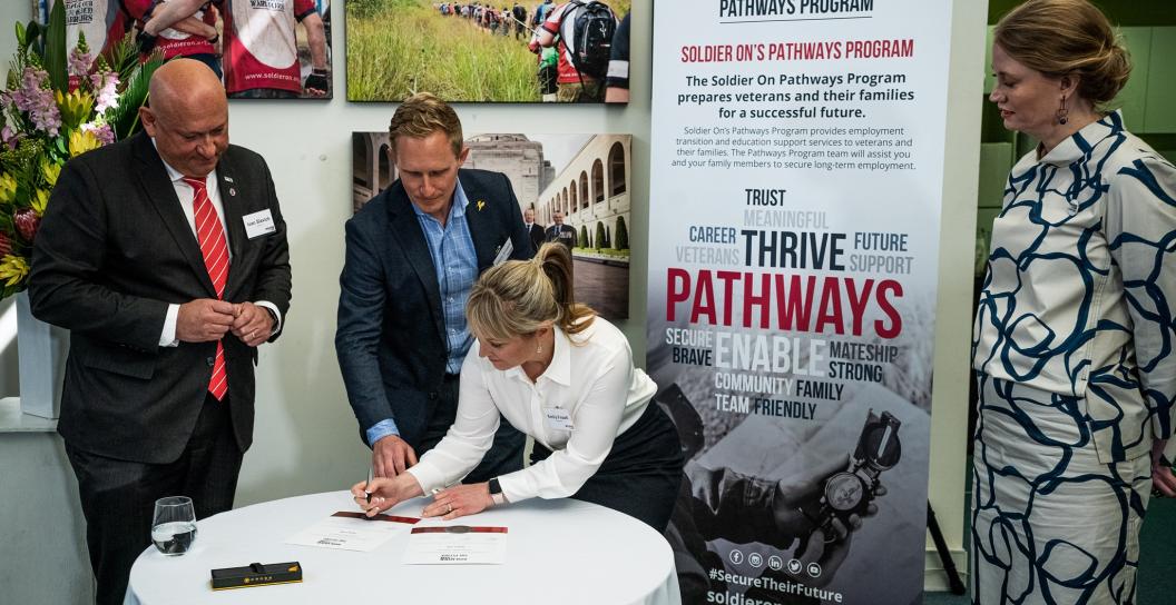 Two people signing document