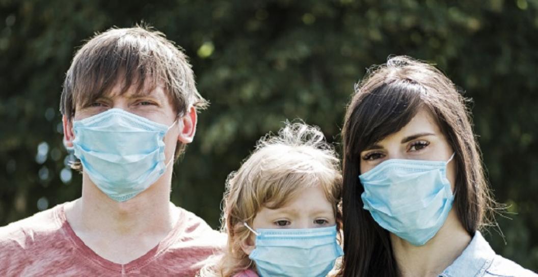 Man, child and woman wearing face masks